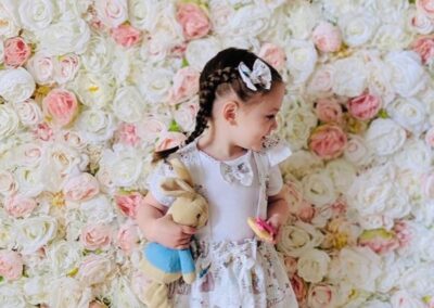 little girl and flower wall